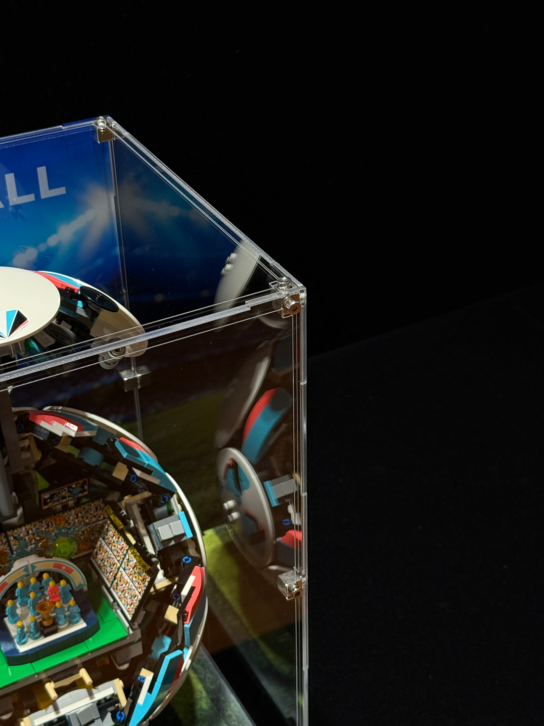 Acrylic display case for LEGO Soccer Ball 42019 on a stadium background