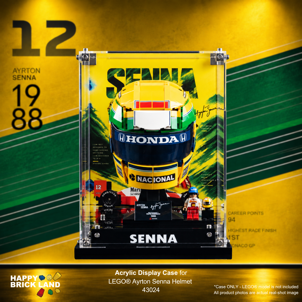 Acrylic display case featuring a LEGO Ayrton Senna helmet from 1988, mounted on a black base with printed race graphics and signatures. The product is shown against a yellow and green graphic background with 'Happy Brick Land' branding and text specifying the LEGO model is not included.