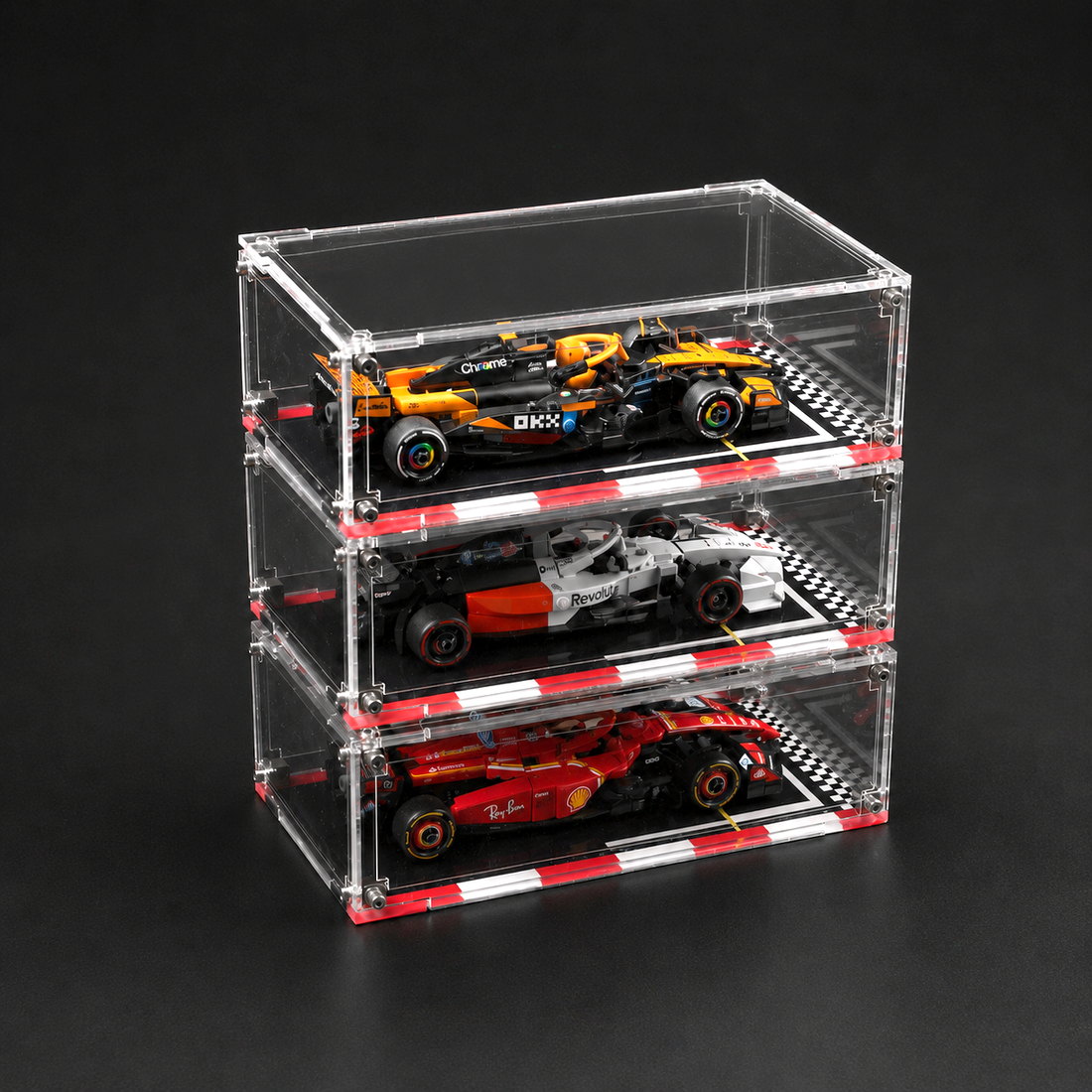 Stack of three clear acrylic car models on a black background