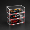 Stack of three clear acrylic car models on a black background