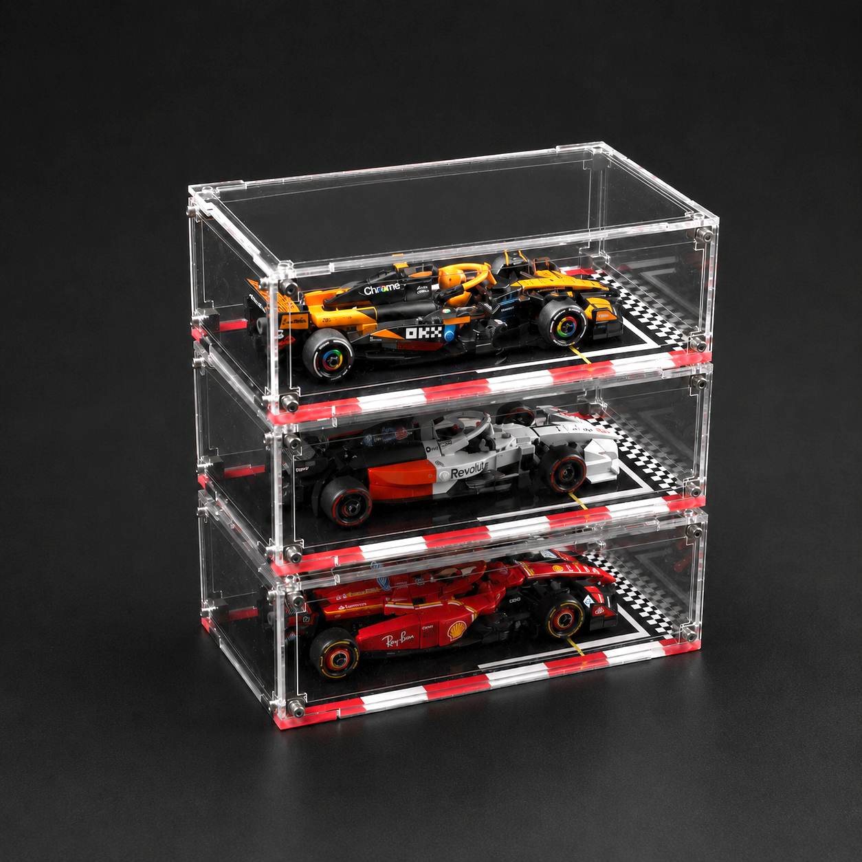 Stack of three clear acrylic car models on a black background
